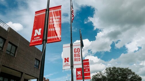 Flags outside the Wick Alumni Center welcome visitors
