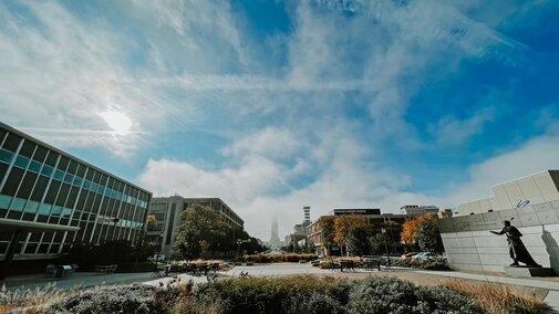 Fog covers the top of the Capitol in the distance in a view from the College of Journalism and Mass Communications