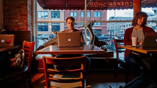 A student works on the computer in The Mill Coffee