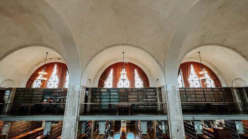 The library in the State Capitol Building, which features large arched windows and rows of books