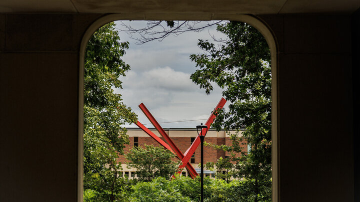 The &quot;Old Glory&quot; sculpture is framed by an opening on the east side of Hamilton Hall.