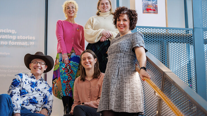 Members of the Media Stamped team on a set of stairs.