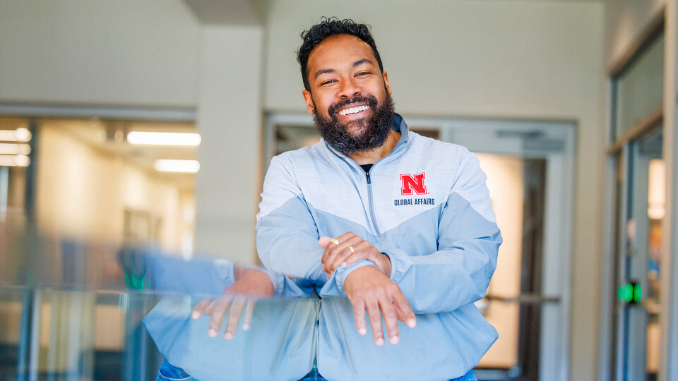 Staff member leaning on railing inside student union