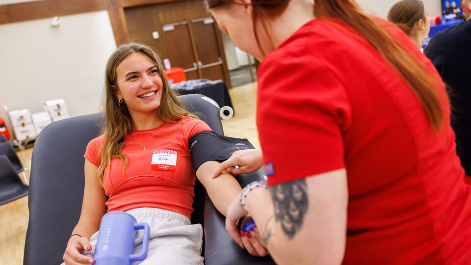 Student smiling as she gets ready to donate blood