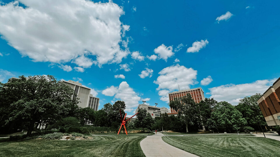 Campus greenspace with sculpture Hamilton Hall and Oldfather