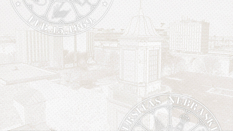 Black and white screened aerial image of campus with seal superimposed over the top