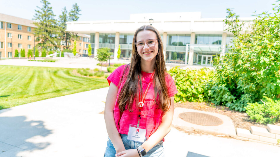 Student standing outside Dinsdale Family Learning Commons