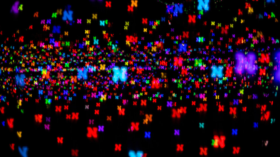Multicolored Nebraska N logos on black background