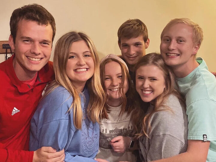 Students hugging each other in group photo