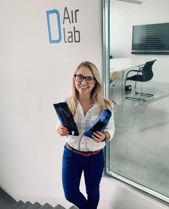 Allison Porter Carpenter holding first prototypes of soft knee exoskeleton for master’s thesis, taken at the D-Air Lab in Vicenza Italy.&nbsp;