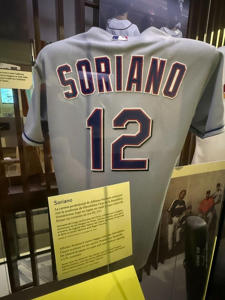 Alfonso Soriano Texas Rangers jersey hangs in display in the ¡Viva Baseball! exhibit at the National Baseball Hall of Fame and Museum. 