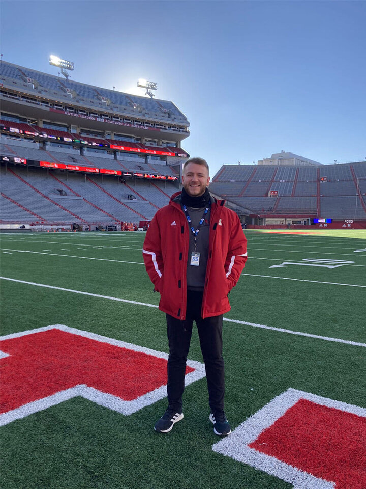 Sam Laughlin standing in the endzone at Memorial Stadium on a sunny fall day.