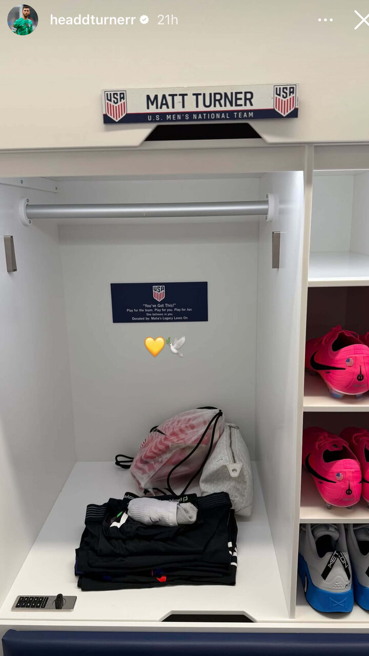 Locker with labeled nameplate, folded clothing, a drawstring bag, and neon pink soccer cleats on shelves.
