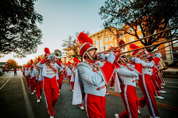 The band plays down the street past the Nebraska Union during the homecoming parade