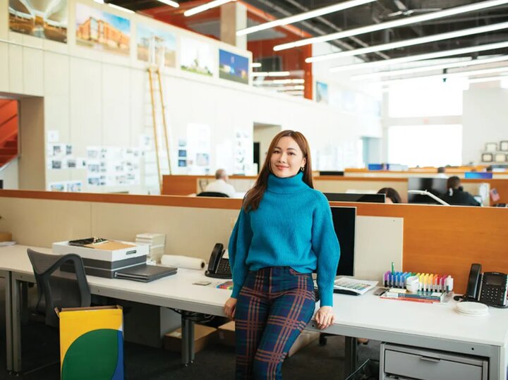 Phuong smiles for a photo at her desk