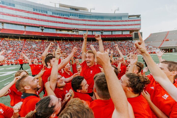 Drew Carlson, a then-freshman trumpet player from North Platte, is hoisted in the arms of the trumpet section after winning the drill down competition in 2022.