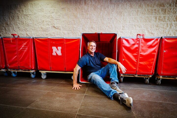 Larry smiles for a photo leaning into the red move-in carts
