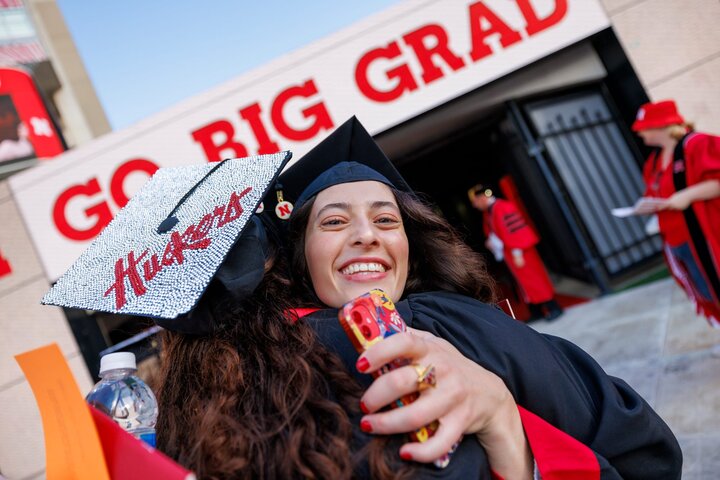 Students hug during graduation