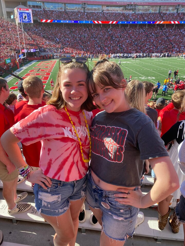 Carly and a friend take a photo in the stands of Memorial Stadium during a game