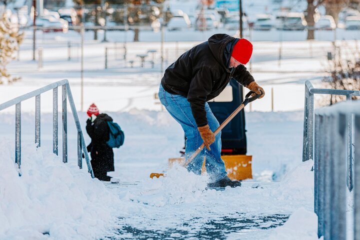Kevin scoops snow on campus after a winter storm