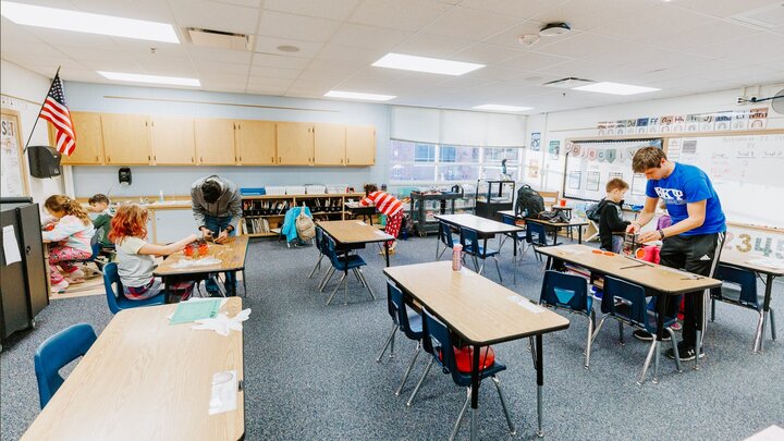 Nebraska Honors students Spencer Knight, right, and Rohan Tatineni, left, work with Riley Elementary students in their after-school STEM club. The students built a rubber-band-powered cars, raced them, and made modifications to improve them.