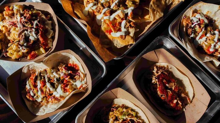 A table of tacos and nachos from Muchacho’s