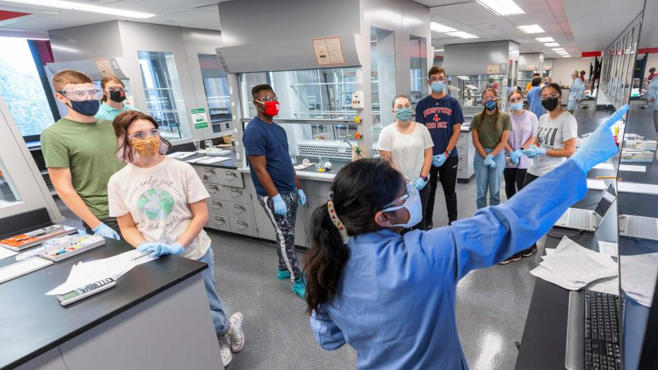 Masked students and faculty in lab