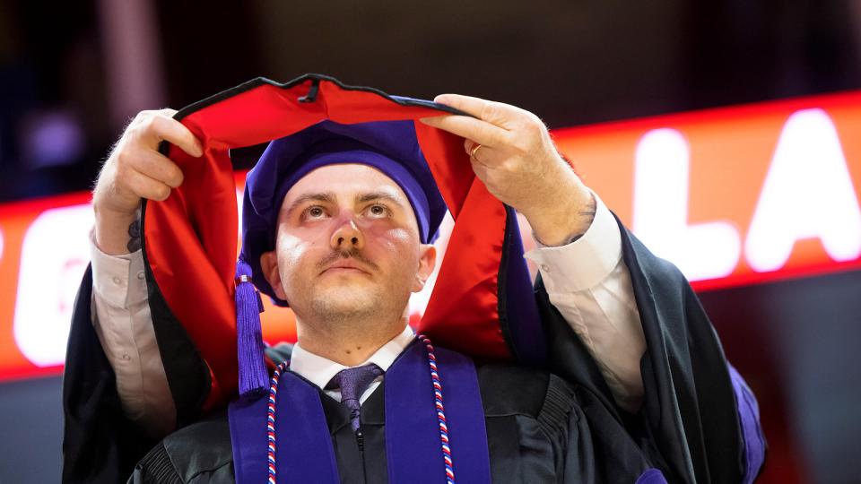 Student receiving law degree decoration at graduation