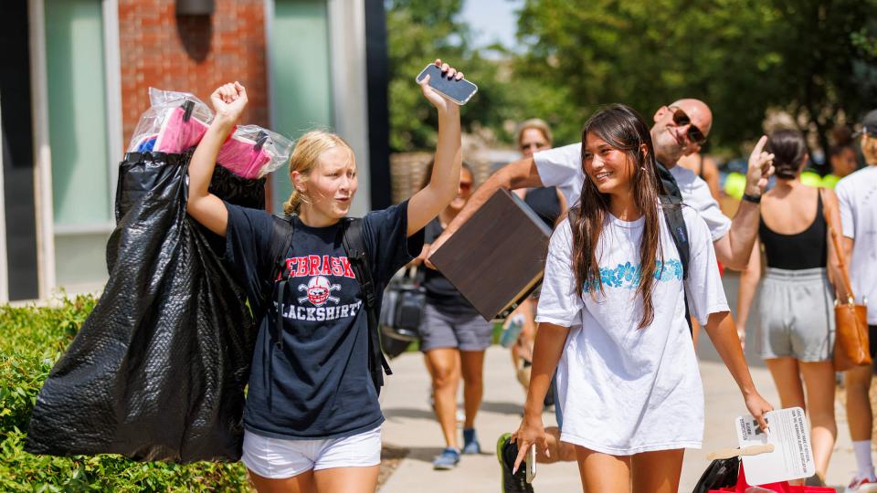 Students moving into residence hall with families