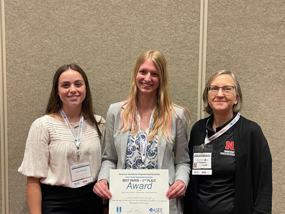Summer undergraduate engineering education researchers Emily Stratman (left) and Kayla Ney (center) alongside mentor Dr. Diefes-Dux (right) receive 2nd place in best paper award in the first-year programs division at the National Engineering Education Conference in 2022.