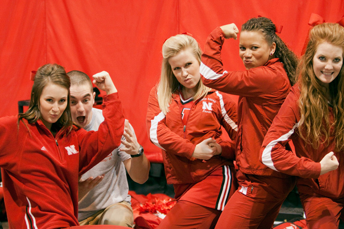 Cheerleaders posing with flexed arms